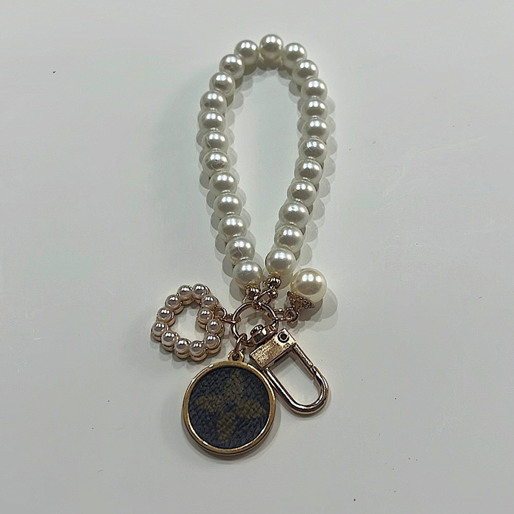 Reworked lv Pearl wristlet charm keychain featuring a heart